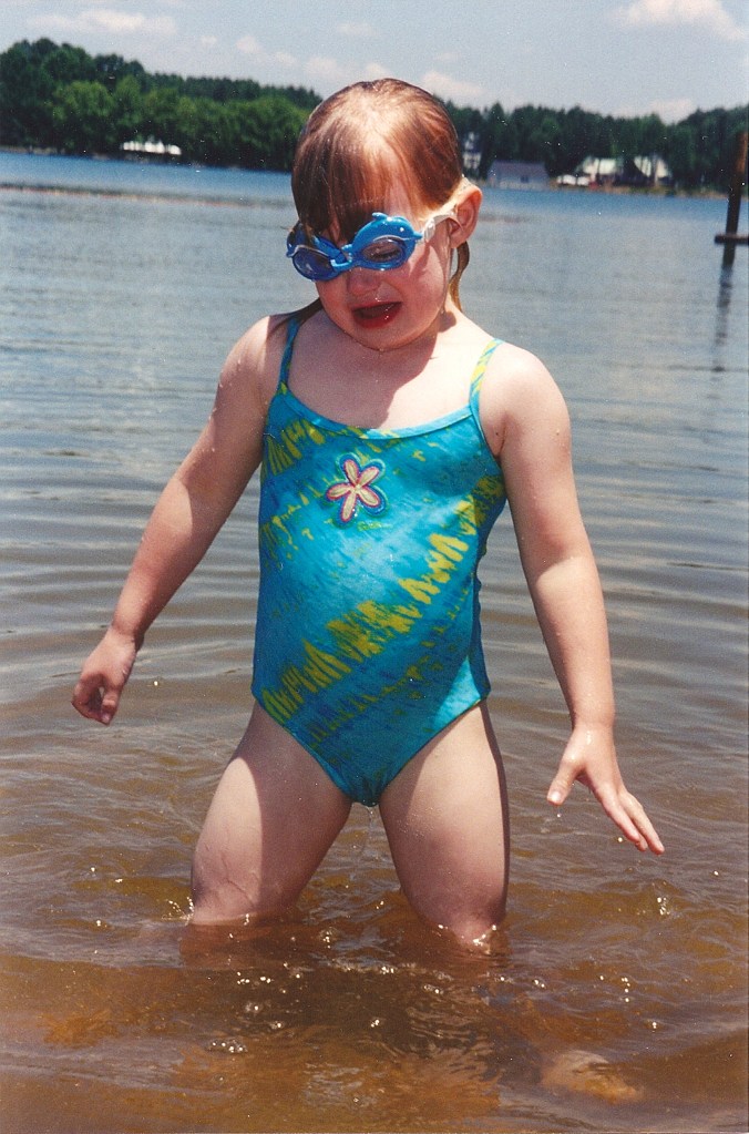 Girl with goggles in a lake.